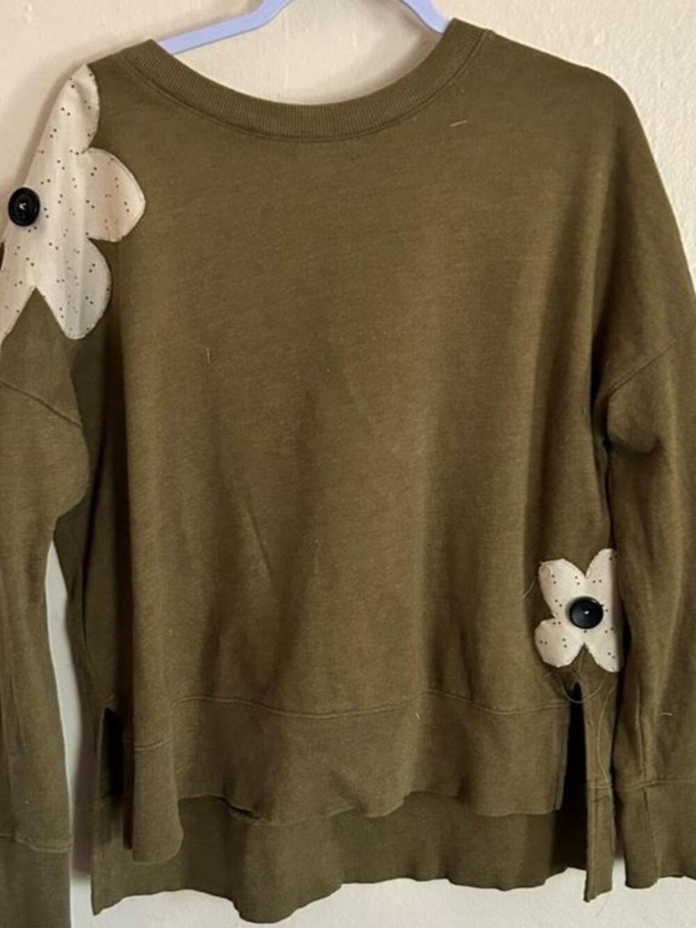 Soft olive sweatshirt with handmade white floral patches and vintage buttons